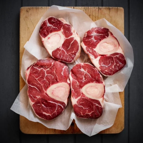 Fresh Beef Steaks Arranged Neatly on a Wooden Cutting Board.