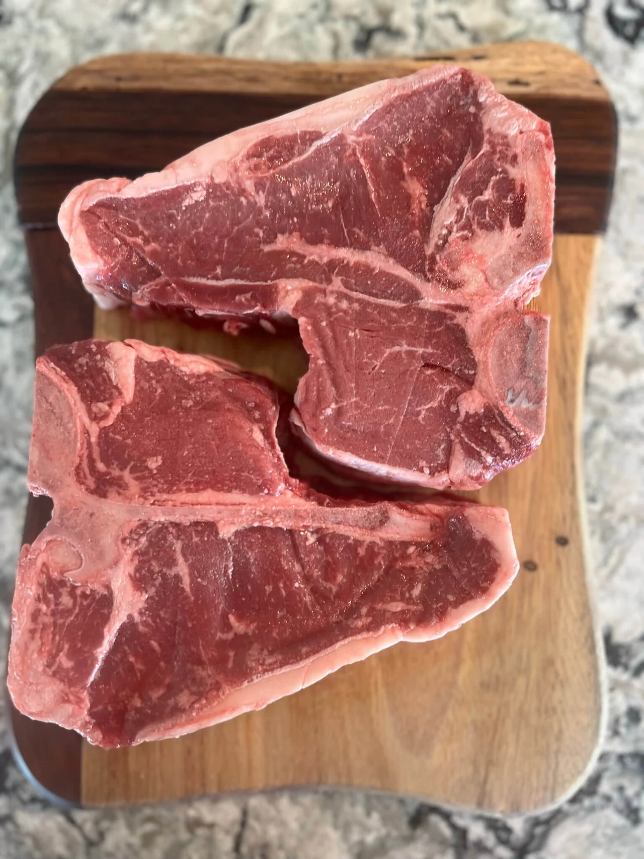 Two Pieces of Meat on a Cutting Board.